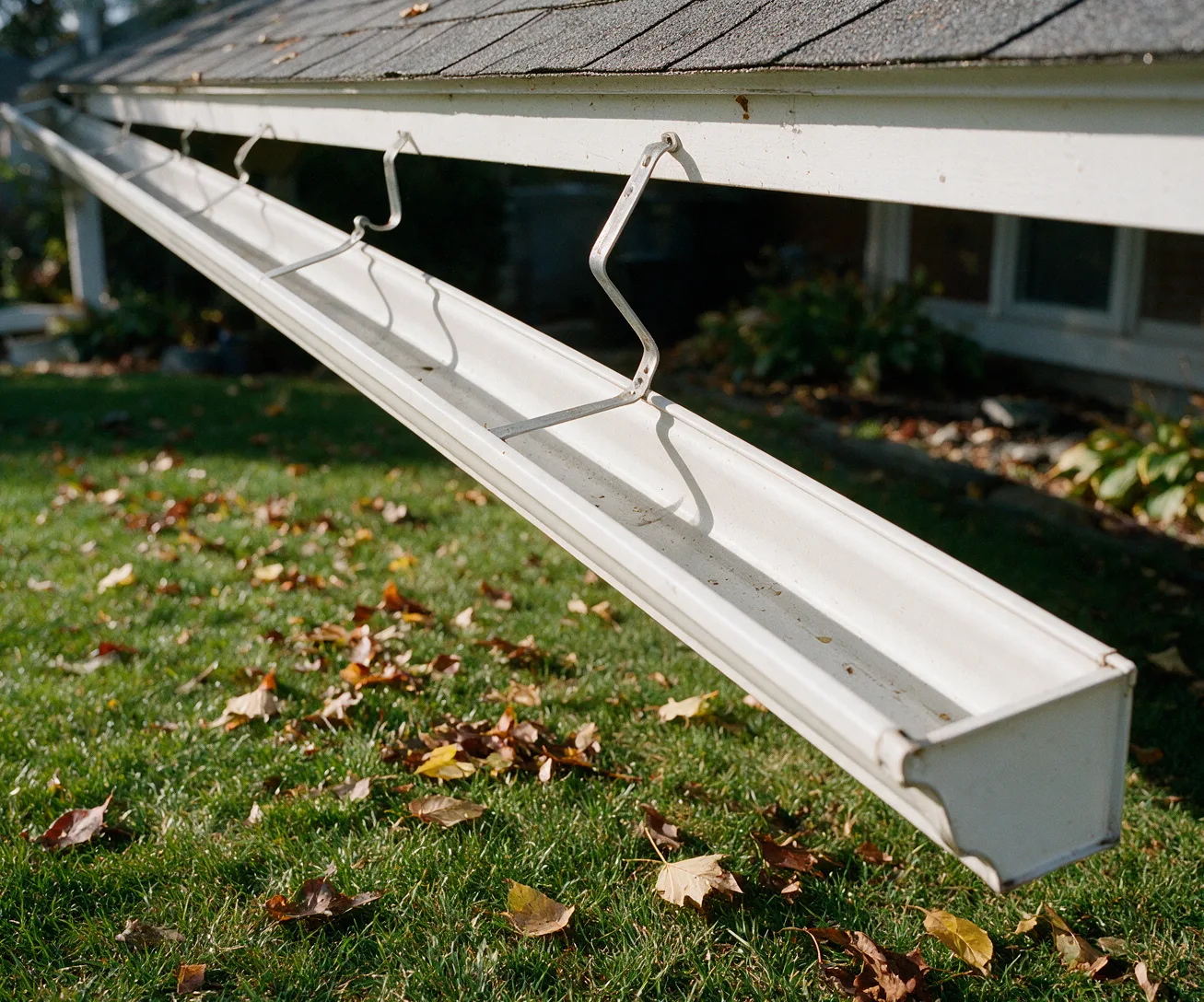 A gutter torn loose by wind